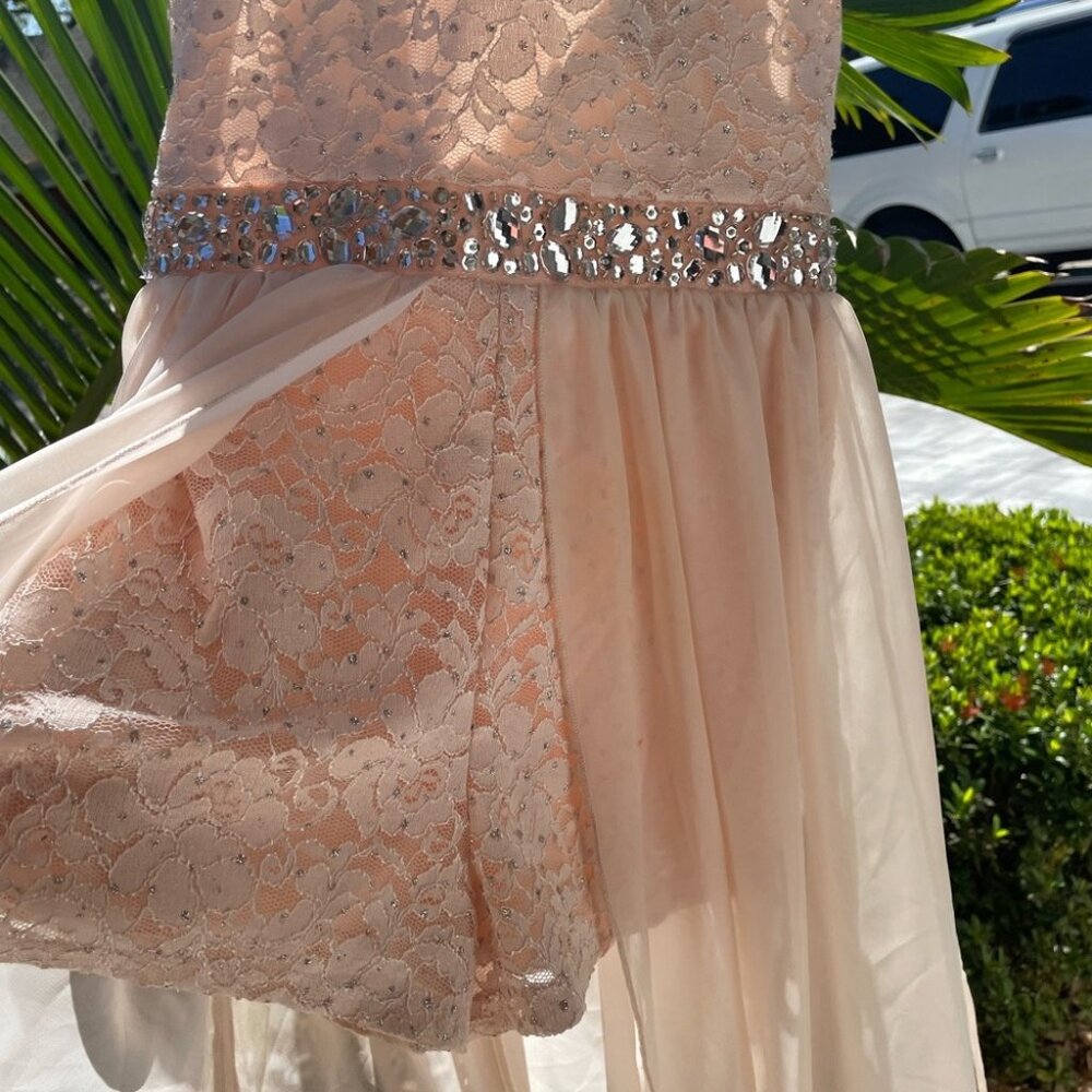 Girls amazingly beautiful high-low romper dress with sequins and sheer overlay.